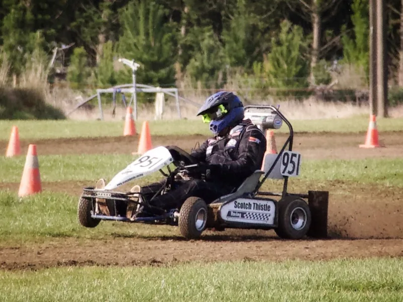 Kart 951 in Scotch Thistle Racing colours, sliding through a grass-track corner