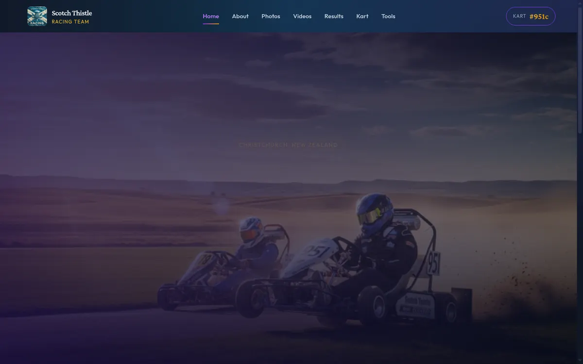 The Scotch Thistle Racing home page: two grass karts, 951 leading, throwing dirt through a corner at dusk